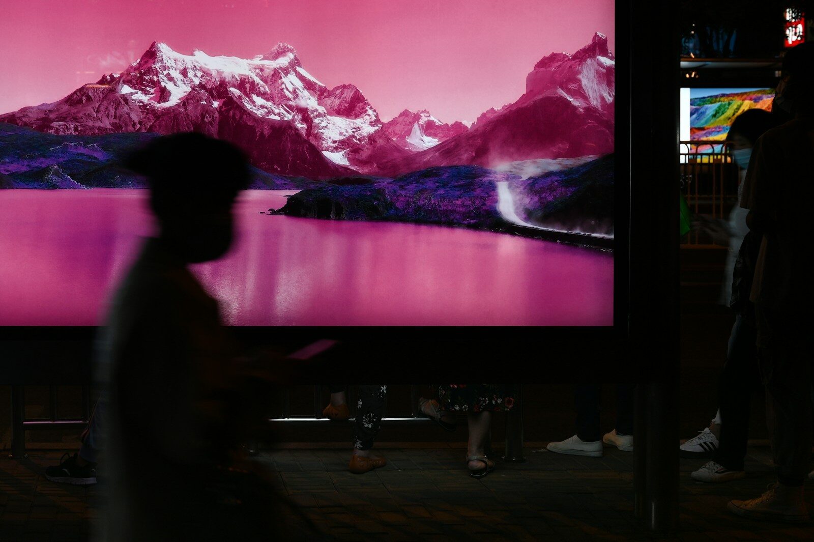 Photo by Jimmy Jin black flat screen tv turned on near white and black mountains